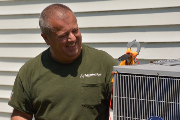 PFO Heating & Air Conditioner HVAC technician tending to an air conditioner
