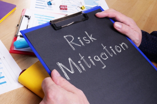 Risk Mitigation written on black paper on a clipboard depicting Off-Season Heating System Damage